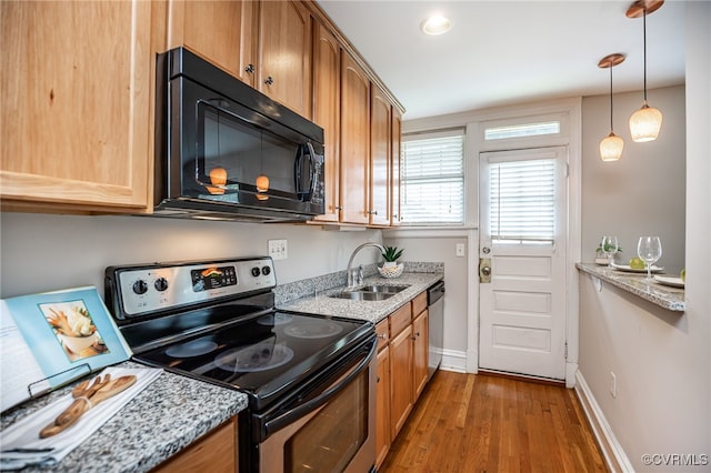 1112 Roseneath Rd Unit U1, Richmond, VA 23230 - kitchen with stainless steel appliances, wood finished floors, decorative light fixtures, light stone counters, and brown cabinets
