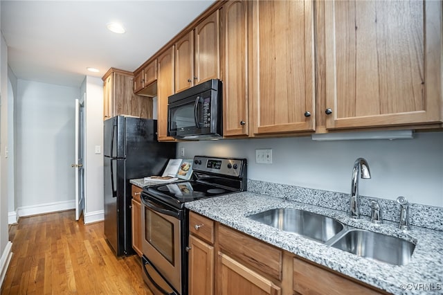 1112 Roseneath Rd Unit U1, Richmond, VA 23230 - kitchen with stainless steel electric range, black microwave, light wood-style floors, light stone countertops, and recessed lighting