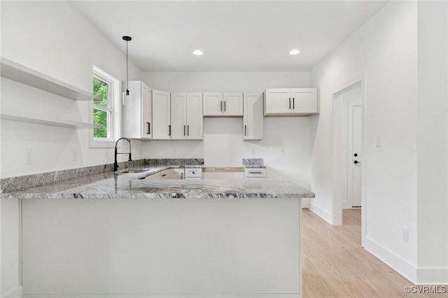 425 Palomino Dr, Louisa, VA 23093 - kitchen with a peninsula, light wood-style flooring, light stone counters, pendant lighting, and recessed lighting