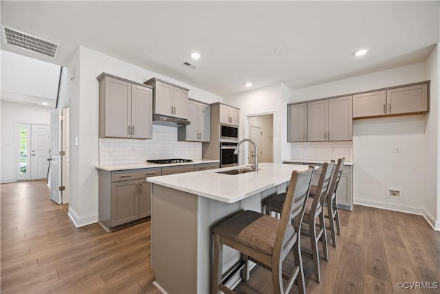 7204 Leire Ln, Moseley, VA 23832 - kitchen featuring gray cabinetry, appliances with stainless steel finishes, dark wood-style floors, backsplash, and recessed lighting