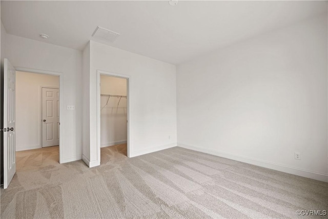 7204 Leire Ln, Moseley, VA 23832 - unfurnished bedroom featuring light colored carpet, a walk in closet, and a closet