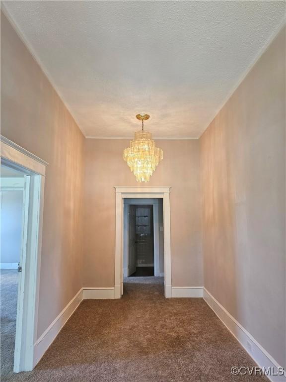 116 Fairfax Ave, Colonial Heights, VA 23834 - corridor with dark colored carpet, a chandelier, and a textured ceiling