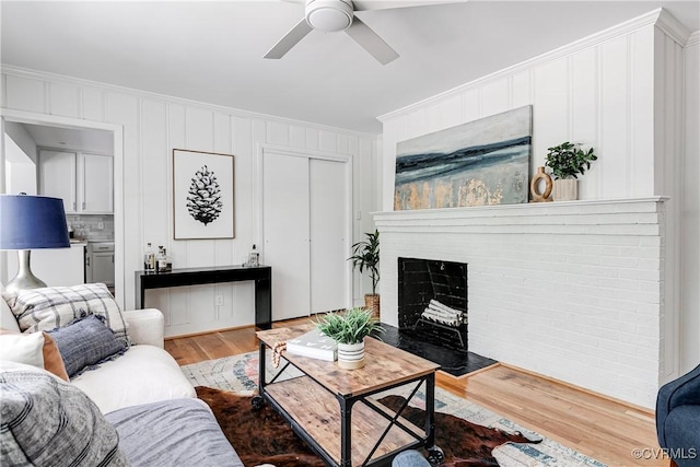 7654 Cherokee Rd, Richmond, VA 23225 - living area with crown molding, wood finished floors, ceiling fan, and a brick fireplace