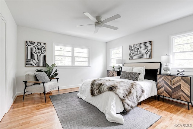 7654 Cherokee Rd, Richmond, VA 23225 - bedroom with multiple windows, light wood-style floors, and a ceiling fan
