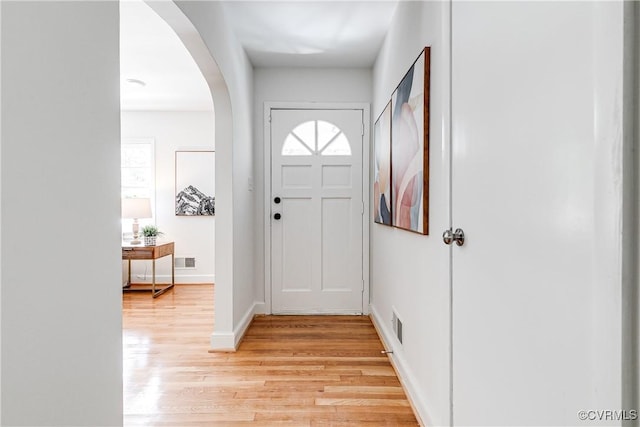 7654 Cherokee Rd, Richmond, VA 23225 - foyer featuring light wood finished floors, arched walkways, and plenty of natural light