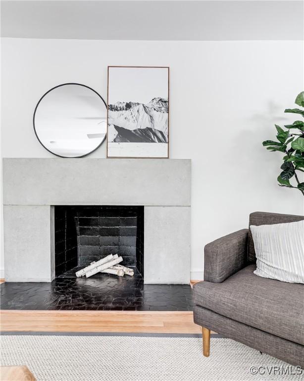 7654 Cherokee Rd, Richmond, VA 23225 - living room featuring a fireplace with flush hearth and wood finished floors