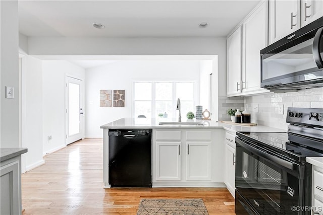 7654 Cherokee Rd, Richmond, VA 23225 - kitchen featuring black appliances, healthy amount of natural light, a peninsula, backsplash, and recessed lighting