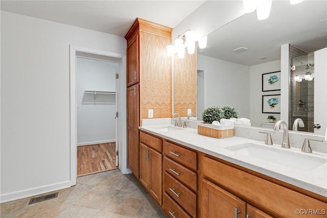 7654 Cherokee Rd, Richmond, VA 23225 - bathroom with double vanity, tiled shower, and a walk in closet