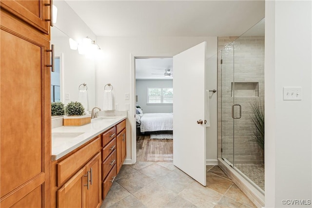 7654 Cherokee Rd, Richmond, VA 23225 - bathroom with double vanity, a shower stall, connected bathroom, a ceiling fan, and tile patterned floors