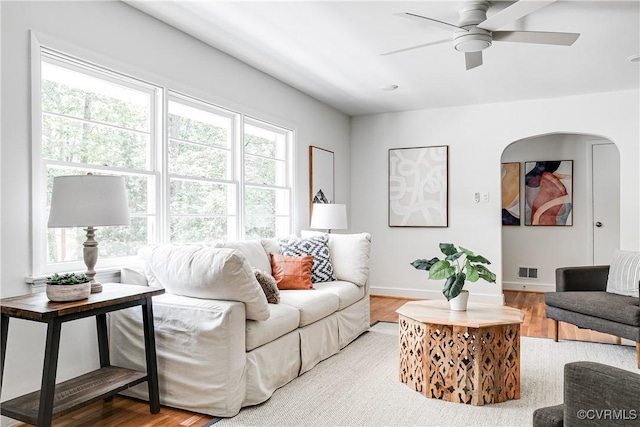 7654 Cherokee Rd, Richmond, VA 23225 - living area with wood finished floors, plenty of natural light, a ceiling fan, and arched walkways