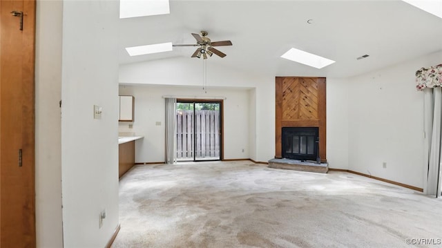 4804 Hackney Rd, Richmond, VA 23234 - unfurnished living room featuring a skylight, a ceiling fan, a large fireplace, light carpet, and vaulted ceiling
