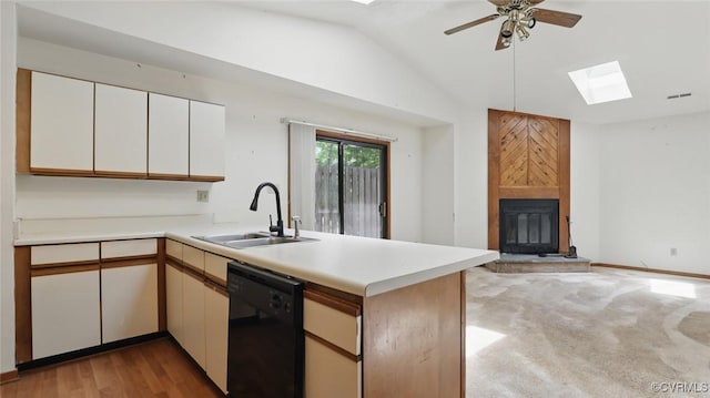 4804 Hackney Rd, Richmond, VA 23234 - kitchen with dishwasher, a skylight, a peninsula, a fireplace, and light countertops