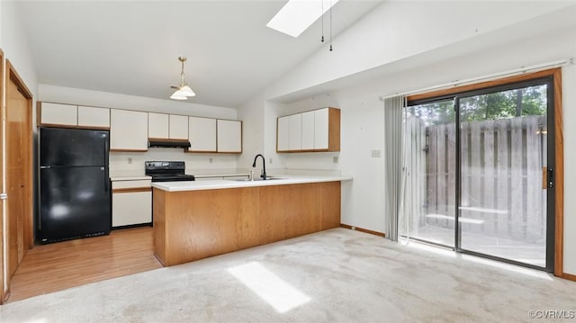 4804 Hackney Rd, Richmond, VA 23234 - kitchen with black appliances, a skylight, under cabinet range hood, lofted ceiling, and white cabinetry
