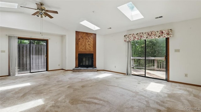 4804 Hackney Rd, Richmond, VA 23234 - unfurnished living room featuring a skylight, a fireplace, lofted ceiling, plenty of natural light, and carpet flooring