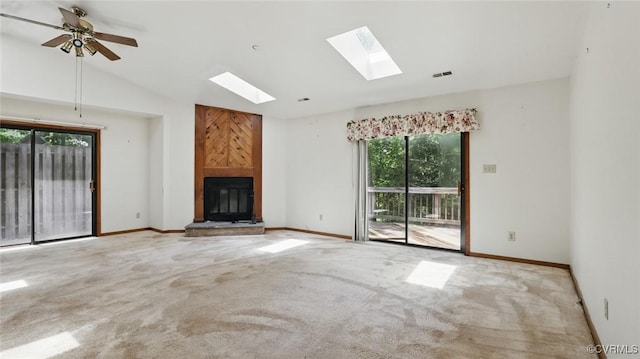 4804 Hackney Rd, Richmond, VA 23234 - unfurnished living room featuring a skylight, a fireplace, carpet floors, vaulted ceiling, and a ceiling fan