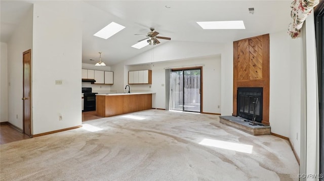 4804 Hackney Rd, Richmond, VA 23234 - unfurnished living room featuring a skylight, light colored carpet, lofted ceiling, a ceiling fan, and a fireplace
