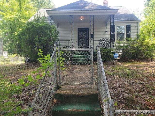 1507 Carter St, Richmond, VA 23220 - view of front of home with a chimney, covered porch, and roof with shingles