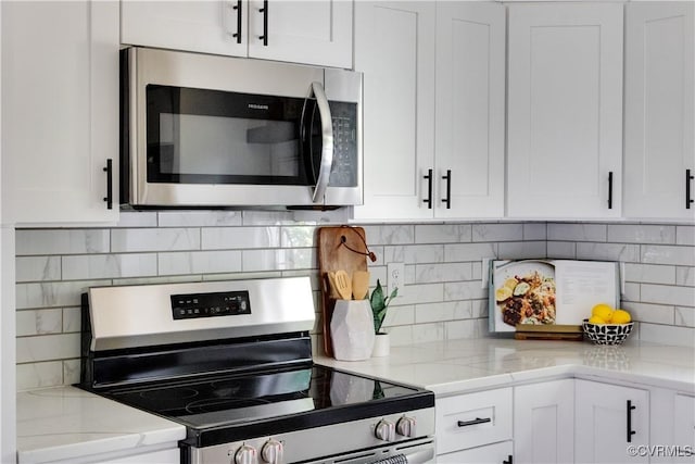 2914 Griffin Ave, Richmond, VA 23222 - kitchen featuring appliances with stainless steel finishes, white cabinets, decorative backsplash, and light stone countertops