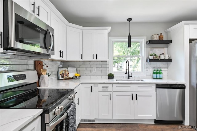 2914 Griffin Ave, Richmond, VA 23222 - kitchen featuring stainless steel appliances, open shelves, white cabinetry, tasteful backsplash, and light stone counters