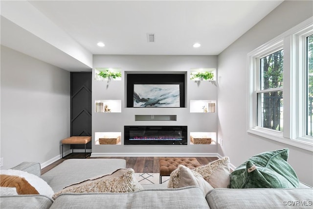 2914 Griffin Ave, Richmond, VA 23222 - living room with wood finished floors, a glass covered fireplace, and recessed lighting