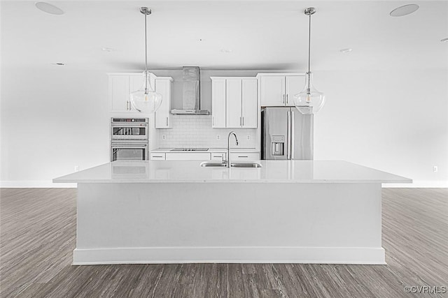 2642 Lassen Walk Unit B, Henrico, VA 23294 - kitchen featuring stainless steel appliances, wall chimney exhaust hood, a center island with sink, wood finished floors, and light countertops