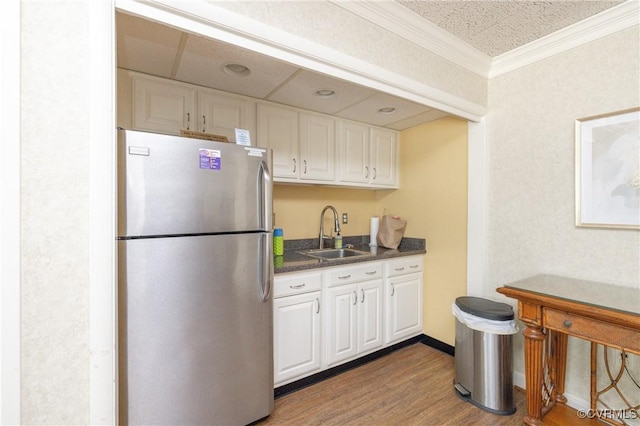 2956 Hathaway Rd Unit U606, Richmond, VA 23225 - kitchen with freestanding refrigerator, white cabinets, dark countertops, wood finished floors, and crown molding
