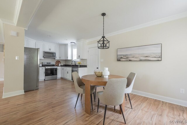 4806 Cutshaw Ave, Richmond, VA 23230 - dining space with light wood finished floors and ornamental molding