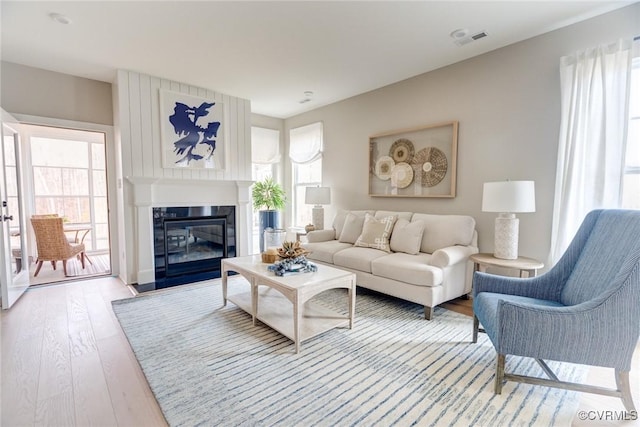 15730 Canoe Pointe Loop, Moseley, VA 23120 - living area with light wood-style floors and a fireplace with flush hearth