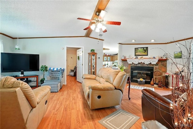 967 Ampthill Rd, Cartersville, VA 23027 - living room featuring crown molding, a textured ceiling, light wood finished floors, a ceiling fan, and a fireplace
