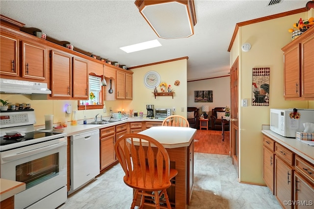 967 Ampthill Rd, Cartersville, VA 23027 - kitchen featuring white appliances, under cabinet range hood, crown molding, light countertops, and a kitchen island
