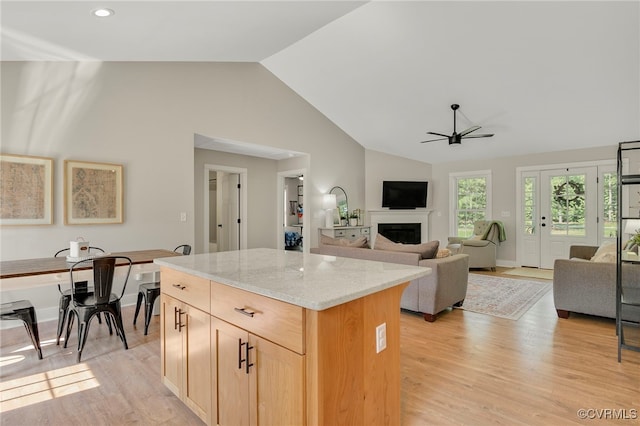 1380 Locust Hill Rd, Aylett, VA 23009 - kitchen featuring a ceiling fan, light brown cabinetry, light stone counters, a kitchen island, and light wood-type flooring