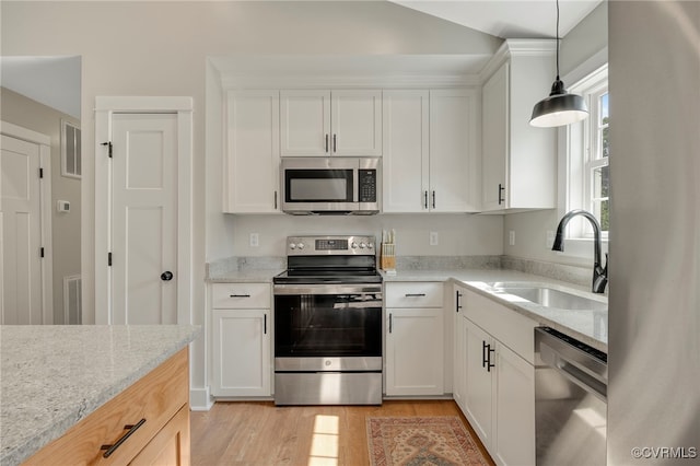 1380 Locust Hill Rd, Aylett, VA 23009 - kitchen featuring stainless steel appliances, light wood-style flooring, white cabinetry, pendant lighting, and light stone counters
