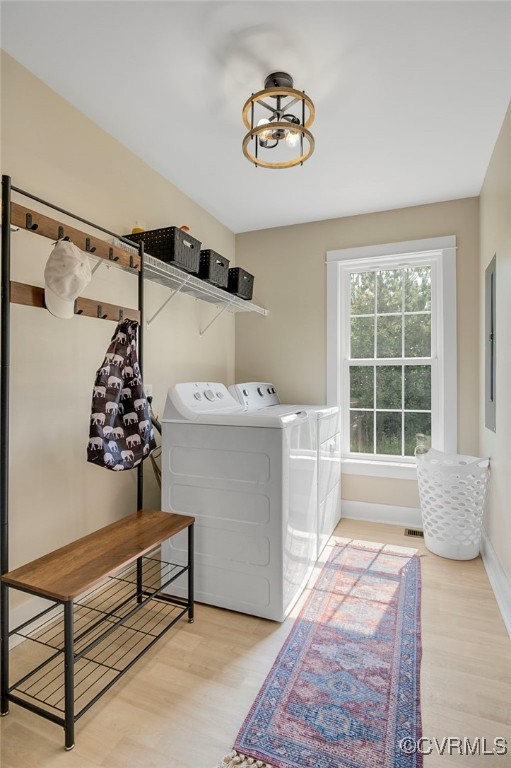 1380 Locust Hill Rd, Aylett, VA 23009 - laundry area featuring washing machine and clothes dryer, wood finished floors, electric panel, and a chandelier