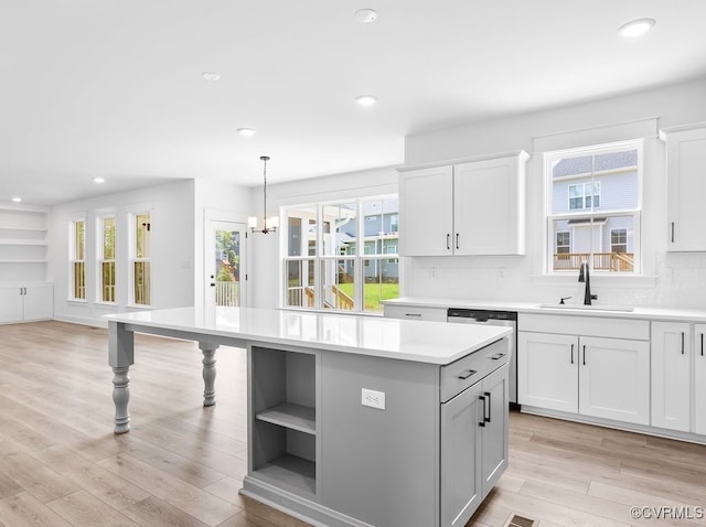 13513 Pinstone Ct, Midlothian, VA 23112 - kitchen featuring a kitchen island, light countertops, open shelves, tasteful backsplash, and light wood-type flooring