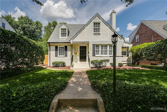 4508 Augusta Ave, Richmond, VA 23230 - english style home with brick siding, a front yard, and a chimney
