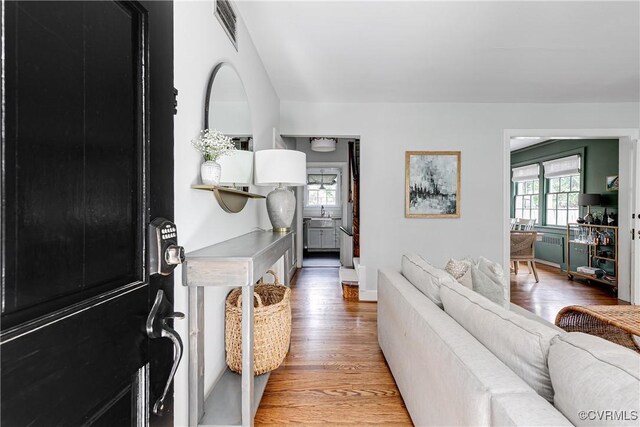 4508 Augusta Ave, Richmond, VA 23230 - corridor with plenty of natural light, light wood-type flooring, and radiator