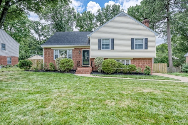 8411 Freestone Ave, Henrico, VA 23229 - tri-level home featuring brick siding, a chimney, and roof with shingles