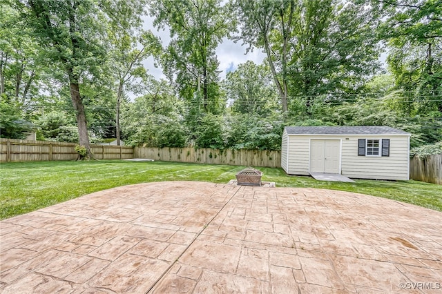 8411 Freestone Ave, Henrico, VA 23229 - fenced backyard featuring a patio, an outdoor fire pit, an outbuilding, and view of scattered trees