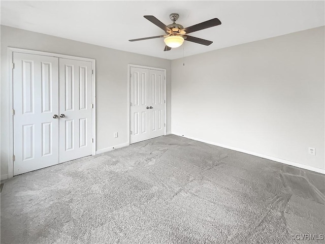 918 N 26th St, Richmond, VA 23223 - unfurnished bedroom with multiple closets, carpet flooring, and a ceiling fan