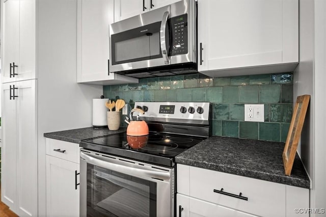 1508 N 29th St, Richmond, VA 23223 - kitchen featuring appliances with stainless steel finishes, white cabinets, tasteful backsplash, and dark stone countertops