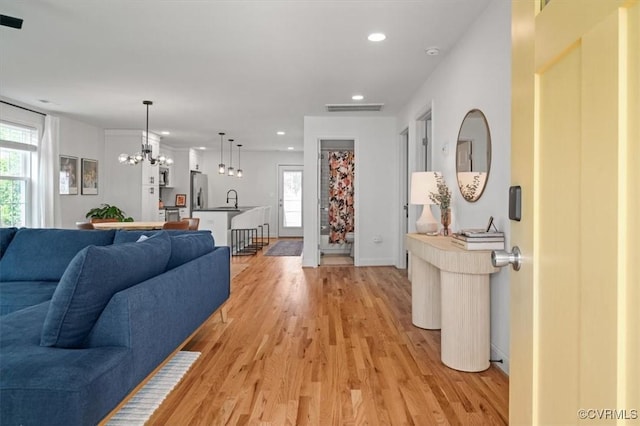 1508 N 29th St, Richmond, VA 23223 - living room with light wood-style flooring, recessed lighting, and a chandelier