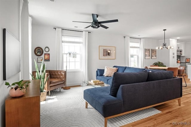 1508 N 29th St, Richmond, VA 23223 - living area featuring light wood-style floors, a chandelier, and ceiling fan