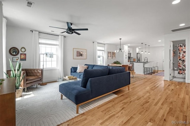 1508 N 29th St, Richmond, VA 23223 - living room with light wood-style flooring, a chandelier, ceiling fan, and recessed lighting