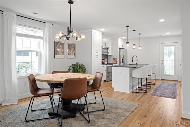 1508 N 29th St, Richmond, VA 23223 - dining space featuring plenty of natural light, light wood-style flooring, recessed lighting, and a chandelier