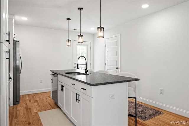 1508 N 29th St, Richmond, VA 23223 - kitchen with a kitchen breakfast bar, light wood-style floors, stainless steel appliances, white cabinets, and recessed lighting