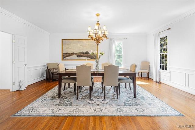 12829 Huntmaster Ln, Henrico, VA 23233 - dining room with a chandelier, wood finished floors, ornamental molding, a wainscoted wall, and a decorative wall