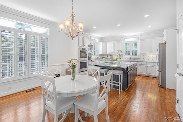 12829 Huntmaster Ln, Henrico, VA 23233 - dining space with a chandelier, light wood-style flooring, ornamental molding, and recessed lighting