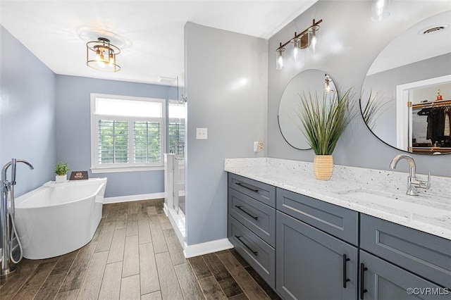 12829 Huntmaster Ln, Henrico, VA 23233 - bathroom with vanity, wood finished floors, a freestanding bath, and a shower stall
