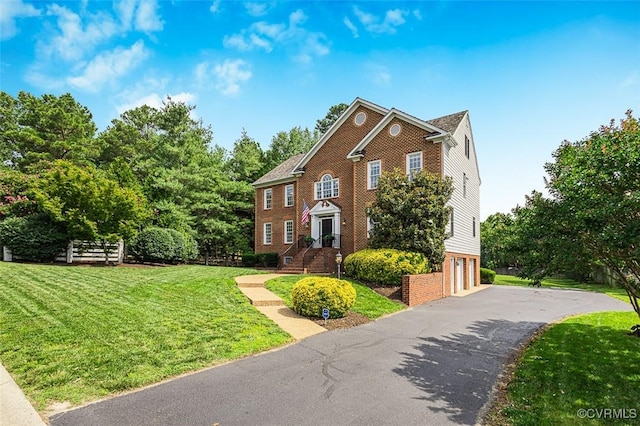12829 Huntmaster Ln, Henrico, VA 23233 - colonial inspired home featuring an attached garage, driveway, and brick siding