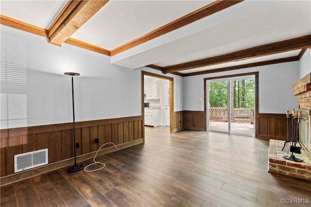 3401 Quail Hill Dr, Chesterfield, VA 23112 - unfurnished living room with a wainscoted wall, beamed ceiling, wood finished floors, and a brick fireplace